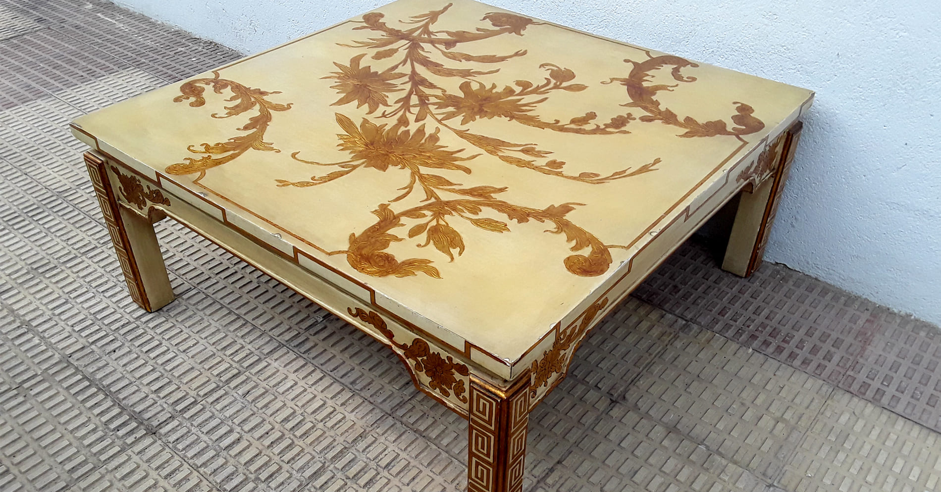 Cream lacquered coffee table with golden floral motifs